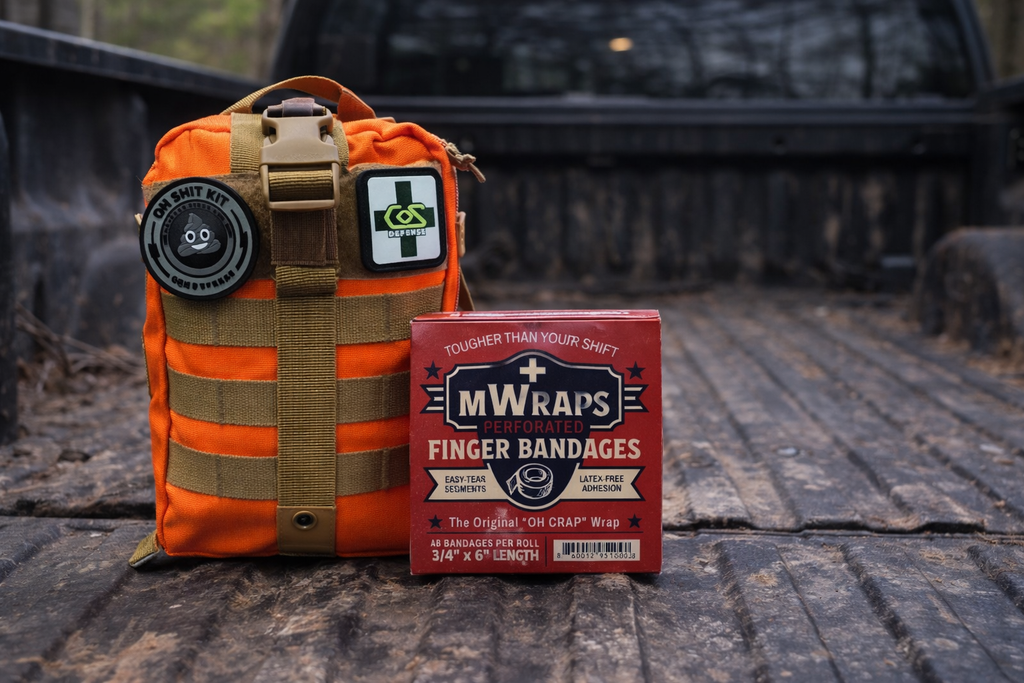 Orange tactical pouch with a bandage box labeled 'MWraps' on a wooden surface.