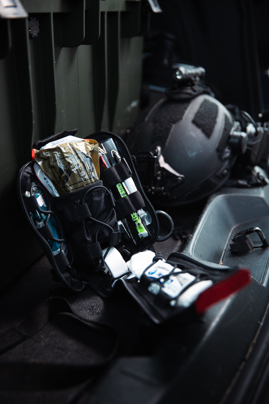 First aid kit on a vehicle seat with helmet in the background