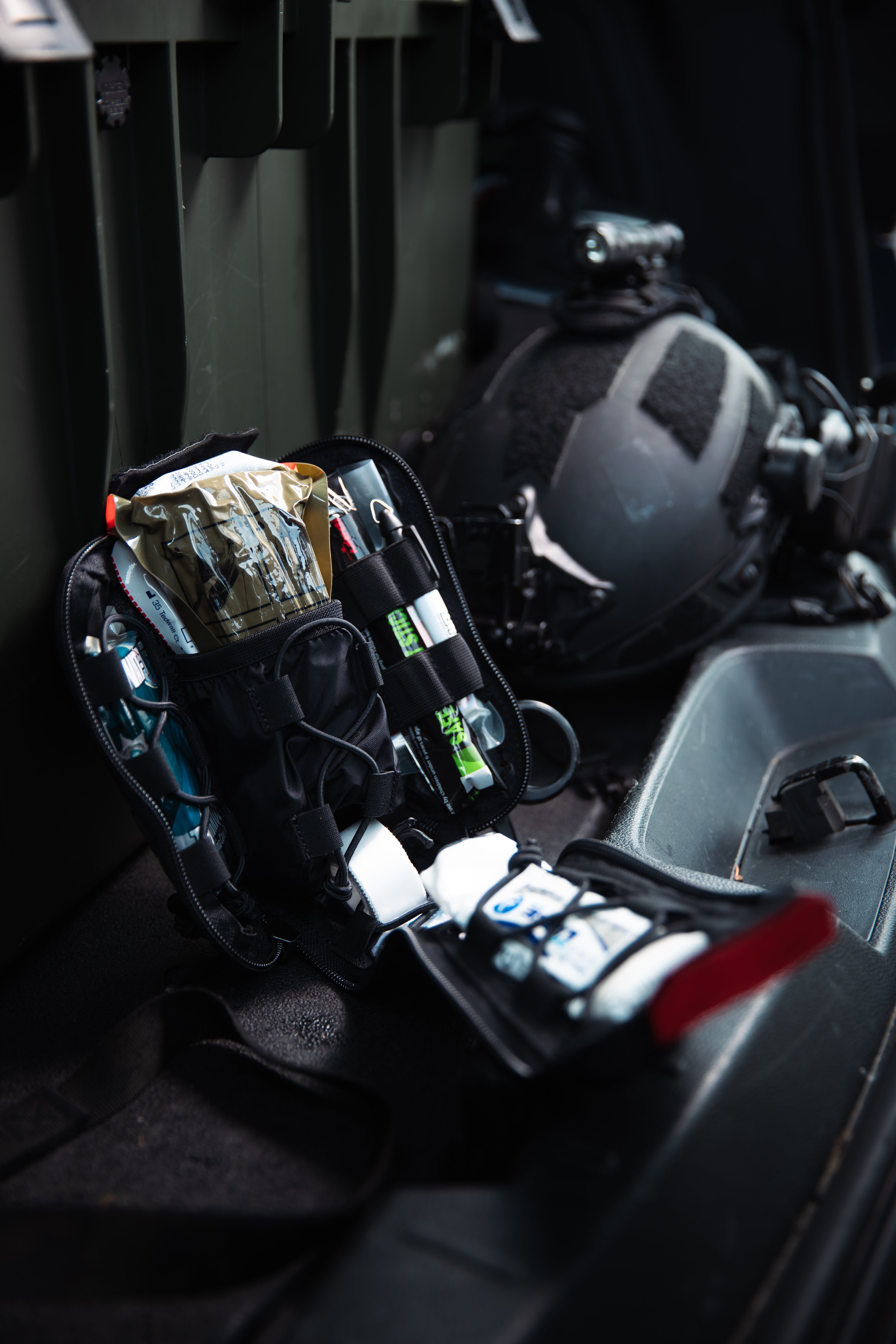 First aid kit on a vehicle seat with helmet in the background