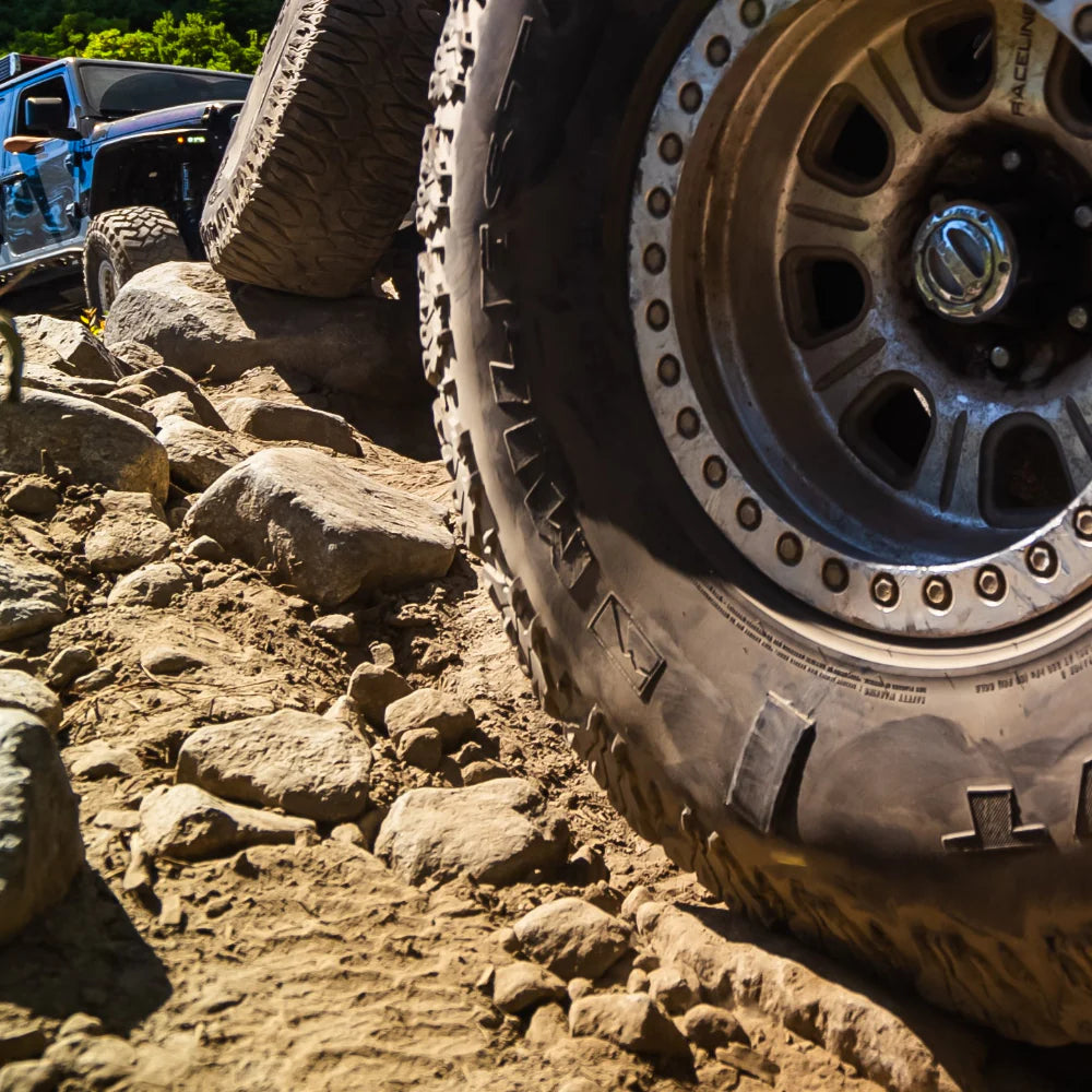 Off-road vehicle tire on a rocky terrain