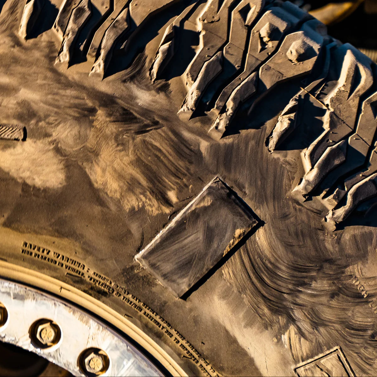 Close-up of a tire tread pattern with visible branding on a vehicle.