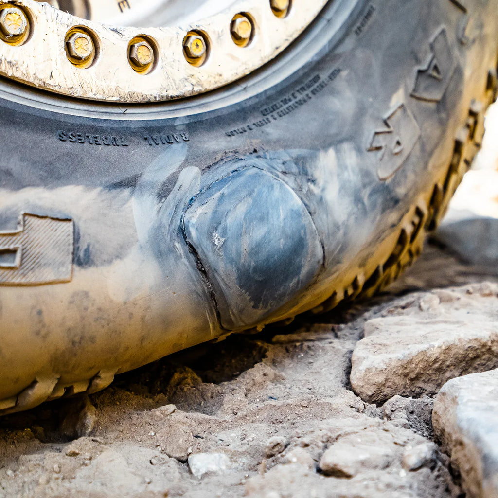 Close-up of a muddy tire on a rough terrain