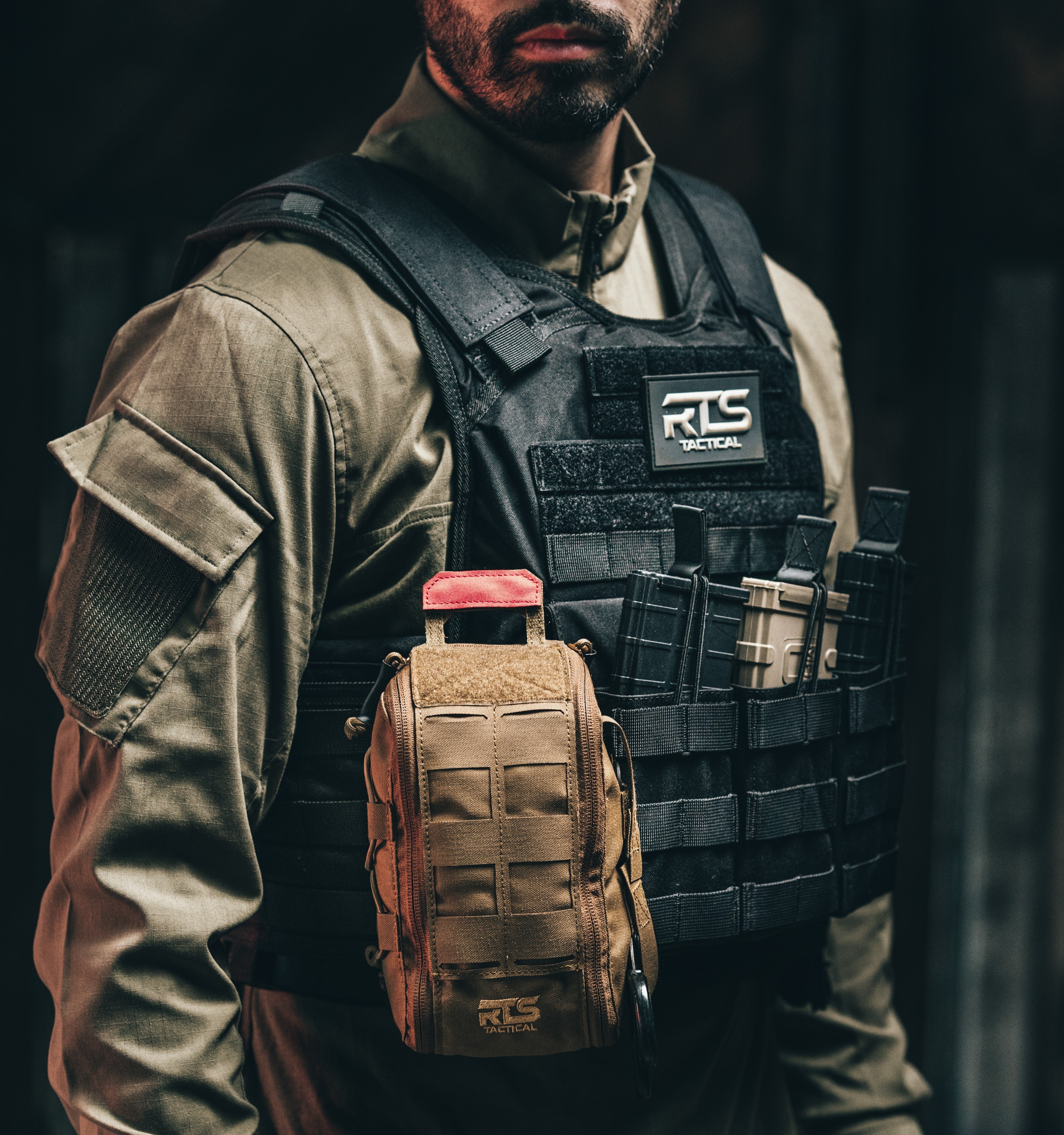 Person wearing a tactical vest with RLS Tactical branding on a dark background