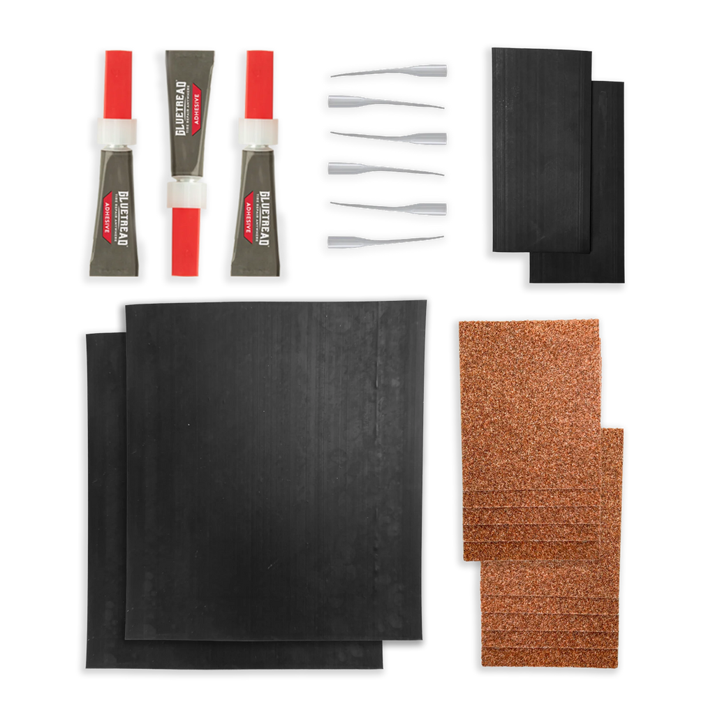 Collection of automotive repair parts including black pads, red and gray tools on a white background