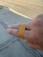 Two fingers with a bandage on a sidewalk